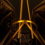 A telescope silhouetted against a star-filled night sky at an observatory